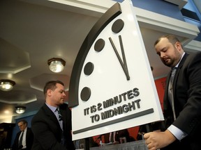 The Bulletin of the Atomic Scientists unveil the 2018 "Doomsday Clock" on Jan. 25, 2018 in Washington, DC. Citing growing nuclear risks and unchecked climate dangers, the group moved the clock to two minutes before midnight, 30 seconds closer and the closest it has been since the height of the Cold War in 1953. (Photo by Win McNamee/Getty Images)