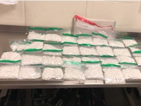 Six people have been arrested, including two pharmacists from Toronto, following an investigation into a suspected opioid trafficking ring that also led to the seizure of more than $500,000 in opioids, one handgun and more than $220,000 in cash.(York Regional Police handout)