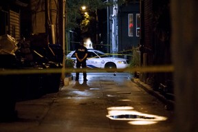 In this file photo taken on July 23, 2018, a Toronto Police officer stands watch at the scene of the Danforth Ave. shooting rampage that killed two and wounded 13 others in Toronto, Ontario, Canada. (Cole Burston/AFP/Getty Images)