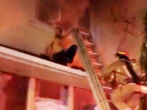A woman was critically injured in a fire on Weston Rd. near Eglinton Ave. on Saturday, Jan. 25, 2020. Toronto firefighters are seen here rescuing a man. (Supplied photo)