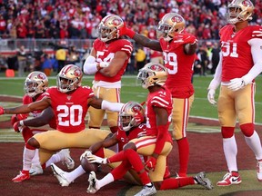 San Francisco 49ers cornerback Richard Sherman poses for a photo with teammates after recording an interception against the Minnesota Vikings in the third quarter in a NFC Divisional Round playoff football game at Levi's Stadium.