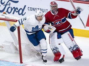 Maple Leafs hopeful Tyler Gaudet slips in between Montreal Canadiens goaltender Charlie Lindgren and his net during pre-season hockey action. (Paul Chiasson/The Canadian Press)