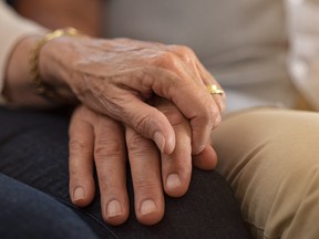 An elderly couple hold hands . (Getty Images)