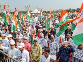 Protesters and members from different organizations like Muslim Central Committees of Dakshina Kannada and Udupi districts hold flags and placards as they demonstrate against India's new citizenship law in Mangalore on Jan. 15, 2020. (STR/AFP via Getty Images)