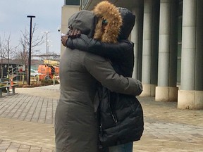 Grief-stricken relatives of Jordan Henry, who was gunned down at a New Year's Eve party in Brampton, embrace outside the Brampton courthouse on Jan. 3, 2020, after attending the appearance of a couple charged in connection with the 17-year-old's murder. (Chris Doucette, Toronto Sun)