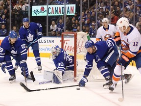 Maple Leafs goalie Michael Hutchinson and defenceman Martin Marincin (52) look to prevent a pass from New York Islanders forward Josh Bailey during the third period at Scotiabank Arena on Saturday night. (Dan Hamilton/USA TODAY Sports)