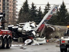 A tractor trailer on its side against an Esso sign at Eglinton and Mavis after a deadly crash on Jan. 13, 2020. (Ernest Doroszuk/Toronto Sun)