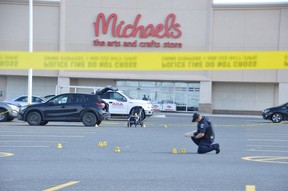 Greater Sudbury Police officers collect evidence at the site of a stabbing incident outside the Michaels store on Marcus Drive on June 3, 2019. A woman and child were injured, while the suspect, a man, also injured himself, police said. JIM MOODIE/Postmedia