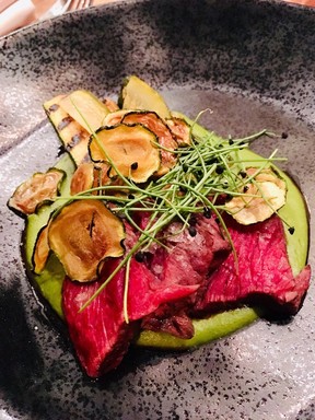 Buttery slices of Highland beef on pea puree with zucchini pickles is a Legende masterpiece.