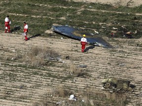In this Wednesday, Jan. 8, 2020 photo, rescue workers search the scene where a Ukrainian plane crashed in Shahedshahr, southwest of the capital Tehran, Iran. THE CANADIAN PRESS/AP-Ebrahim Noroozi