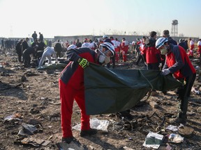 Red Crescent workers check plastic bags at the site where the Ukraine International Airlines plane crashed after take-off from Iran's Imam Khomeini airport, on the outskirts of Tehran, Iran January 8, 2020. Nazanin Tabatabaee/WANA (West Asia News Agency) via REUTERS ATTENTION EDITORS - THIS IMAGE HAS BEEN SUPPLIED BY A THIRD PARTY TPX IMAGES OF THE DAY ORG XMIT: GGGBAG901