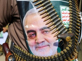 A supporter of the Houthis has a poster attached to his waist of Iranian Major-General Qassem Soleimani, head of the elite Quds Force, who was killed in an air strike at Baghdad airport, during a rally to denounce the U.S. killing, in Saada, Yemen January 6, 2020.