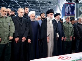 Iran's Supreme Leader Ayatollah Ali Khamenei and Iranian President Hassan Rouhani pray near the coffin of Iranian Major-General Qassem Soleimani, head of the elite Quds Force, who was killed in an air strike at Baghdad airport, in Tehran, Iran, January 6, 2020.