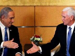 Israeli Prime Minister Benjamin Netanyahu and U.S Vice President Mike Pence prepare to shake hands during their meeting at the U.S embassy in Jerusalem January 23, 2020.