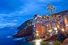 The picture-perfect setting of the Cinque Terre villages (in this case, Riomaggiore) draws millions of tourists annually. (Dominic Arizona Bonuccelli)