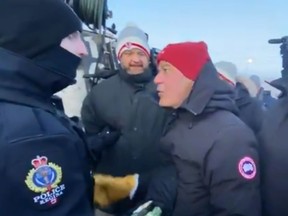 Unifor national president Jerry Dias, left, is arrested by Regina Police on Monday, Jan. 20, 2020. (Screengrab)