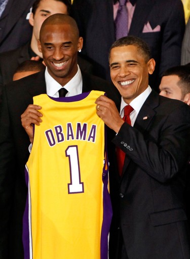 U.S. President Barack Obama (right) poses for photographs with Kobe Bryant (left) and members of the 2009 NBA champions Los Angeles Lakers in the East Room of the White House in Washington, D.C., on Jan. 25, 2010.