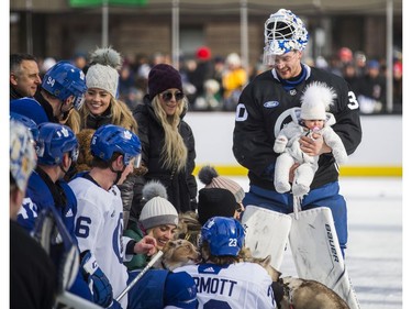Toronto Maple Leafs goalie Michael Hutchinson holds a baby during the team's annual outdoor skate at Nathan Philips Square in Toronto, Ont. on Thursday January 9, 2020. Ernest Doroszuk/Toronto Sun/Postmedia