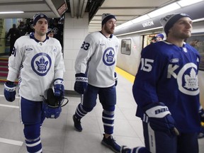 Maple Leafs forwards John Tavares (91), Frederik Gauthier (33), and Alex Kerfoot (15) take the TTC to their annual outdoor practice at City Hall on Thursday, Jan. 9, 2020.