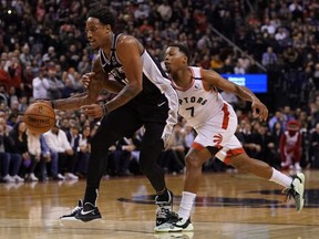 San Antonio Spurs guard DeMar DeRozan gets around Toronto Raptors guard Kyle Lowry at Scotiabank Arena last night. USA TODAY