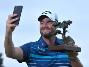 Marc Leishman of Australia poses with the Torrey Pines trophy after winning the final round of the Farmers Insurance Open at Torrey Pines South in San Diego, on Sunday, Jan. 26, 2020.