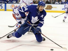 Toronto Maple Leafs forward Auston Matthews (34) controls the puck after colliding with New York Rangers forward Artemi Panarin (10) in overtime at Scotiabank Arena. (Dan Hamilton-USA TODAY Sports)