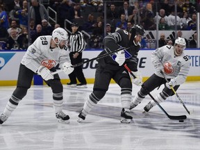 Central Division forward Ryan O'Reilly (centre) of the Blues skates between Pacific Division forwards Leon Draisaitl (left) and Connor McDavid (right) of the Oilers during the 2020 NHL All Star Game 3-on-3 tournament at Enterprise Center in St. Louis on Saturday, Jan. 25, 2020.