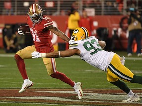 Raheem Mostert of the San Francisco 49ers stiff arms B.J. Goodson of the Green Bay Packers during the second half of the NFC Championship game at Levi's Stadium on Jan. 19, 2020 in Santa Clara, Calif.