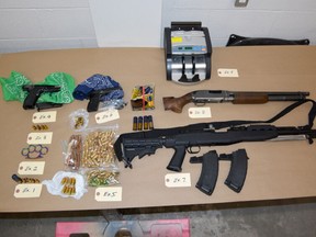 Firearms and ammunition seized by Toronto Police during an investigation involving a white 1992 Cadillac DeVille in the Yonge and Eglinton area.