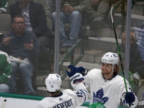Maple Leafs’ Alexander Kerfoot (left) congratulates linemate William Nylander on his goal against the Dallas Stars on Wednesday night. Nylander has scored in five consecutive games. (AP)