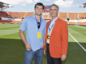 Oliver Luck, right, and his son Andrew Luck, retired NFL quarterback, pose for photos at the inaugural opening at BBVA Compass Stadium in Houston on May 12, 2012.