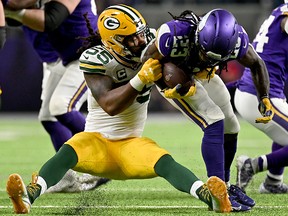 Outside linebacker Za'Darius Smith of the Green Bay Packers tackles running back Mike Boone of the Minnesota Vikings during the game at U.S. Bank Stadium on December 23, 2019 in Minneapolis. (Stephen Maturen/Getty Images)