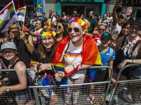 Spectators take in the Pride parade along Yonge St. in downtown Toronto, Ont. on Sunday June 23, 2019.