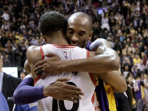 Raptors DeMar DeRozan hugs Los Angeles Lakers Kobe Bryant after Bryant plays last game at the ACC in Toronto, Ont. on Monday December 7, 2015. Craig Robertson/Toronto Sun/Postmedia Network