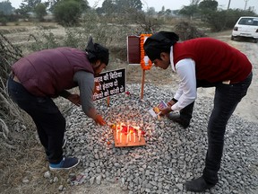 Students light candles next to placards near the spot where a 23-year-old rape victim, who died in a New Delhi hospital last week, was set on fire by a gang of men that included her alleged rapists, in Unnao, in the northern state of Uttar Pradesh, India. (REUTERS/Anushree Fadnavis/File Photo)