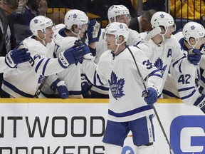 Maple Leafs defenceman Rasmus Sandin is congratulated after scoring his first NHL goal, against the Nashville Predators on Monday night. (Mark Humphrey/The Associated Press)