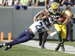 Green Bay Packers' Jordy Nelson catches a pass in front of Seattle Seahawks' Cliff Avril during the first half of an NFL football game Sunday, Sept. 10, 2017, in Green Bay, Wis. (AP Photo/Jeffrey Phelps)