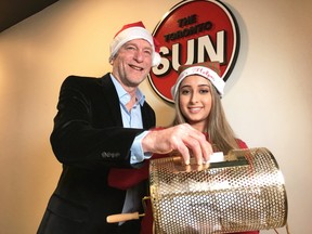 Toronto Sun columnist Mike Strobel and Super Elf Sonya Luthra draw prizewinners in the Sun Christmas Fund for Variety Village in the Toronto Sun newsroom. (Bryan Passifiume/Toronto Sun/Postmedia Network)