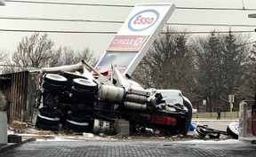 A tractor trailer on its side against an Esso sign at Eglinton and Mavis after a deadly crash on Jan. 13, 2020. (Ernest Doroszuk/Toronto Sun)