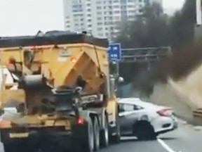 A truck pushes a sideways car on Hwy. 401 near Bayview in an undated video.
