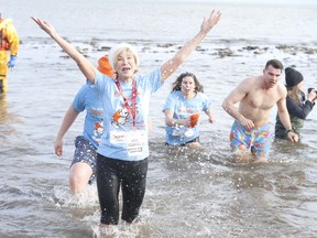 Those taking part in the 2020 Courage Polar Bear Dip for World Vision Canada marked the event's 35th anniversary at Oakville's  Bronte Beach Park on Wednesday. Pictured is  Gaye "Momma Bear" Courage as she comes out of the near-freezing water. (Jack Boland, Toronto Sun)