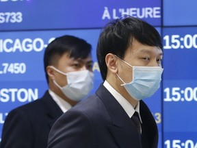Flight crews from China wear masks at Toronto Pearson International Airport on Monday