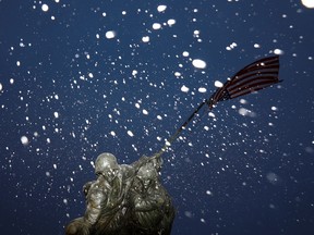 Snow falls during a storm at the Iwo Jima Memorial site in Arlington, Virginia,