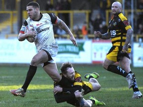 Jordan Rankin of Castleford Tigers tackles Hakim Miloudi of Toronto Wolfpack in Castleford, England yesterday. Getty Images