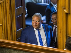 Ontario Premier Doug Ford peers into the Ontario legislature in Sept. 2018