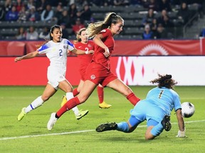 Jordyn Huitema of Canada kicks the ball pass goalie Maria Bermudez and Gabriela Guillen of Costa Rica for a goal during the second half of the Semifinals at the 2020 Concacaf Women's Olympic Qualifying at Dignity Health Sports Park on Feb. 7, 2020 in Carson, Calif.