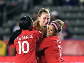 Canada's Jordyn Huitema, centre, celebrates her goal with Ashley Lawrence, left, and Desiree Scott against Costa Rica during the second half of the semifinal at the 2020 Concacaf Women's Olympic qualifying at Dignity Health Sports Park on Feb. 7, 2020 in Carson, Calif.