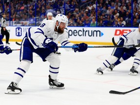 Jake Muzzin, left, of the Toronto Maple Leafs shoots during a game against the Tampa Bay Lightning at Amalie Arena on Feb. 25, 2020 in Tampa, Fla. (Mike Ehrmann/Getty Images)