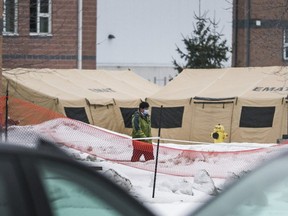 A person wears a face mask outside of Yukon Lodge at CFB Trenton in Trenton, Ont., on   Feb. 11, 2020. (Ernest Doroszuk, Toronto Sun)