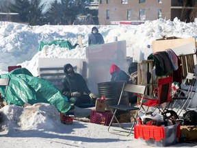 Supporters of the indigenous Wet'suwet'en Nation's hereditary chiefs maintain a railway blockade as part of protests against British Columbia's Coastal GasLink pipeline, in St Lambert, Que., on Feb. 20, 2020. (Reuters)